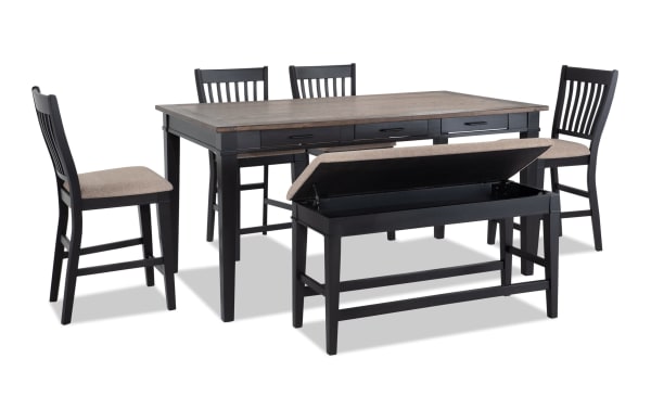 Montana 6 Piece Rustic Counter Height Dining Set with black rubberwood base, oak veneer distressed top, beige polyester fabric seats, six storage drawers, and a storage bench with memory foam upholstery.