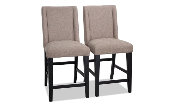 Montana Dining rustic counter height stools set of 2 with beige polyester fabric upholstery, solid back, black wood legs, and memory foam seat.
