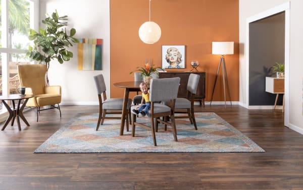 Mid-century modern Bettie 5 Piece Walnut, Russet & Gray Upholstered Round Dining Set with rubberwood, walnut veneers, polyester fabric, button tufted gray chairs, and russet accent wall.