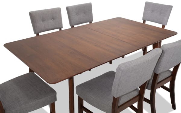 Bettie 7 Piece Walnut & Gray Upholstered Extendable Dining Set with mid-century modern style, gray polyester fabric, button tufting, and walnut veneer table.