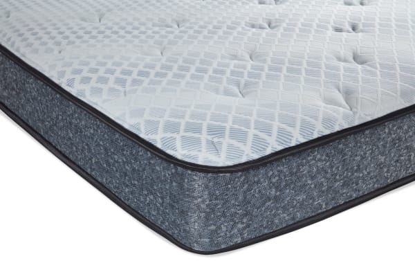 Charm 8.5'' Queen Plush Mattress with quilted knit cover, gray fabric sides, and plush hybrid layers for pressure relief and support.