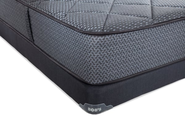 Synergy 10'' Queen Firm Low Profile Mattress Set in gray with quilted top, patterned sides, and dark gray base featuring Bob's brand tag.