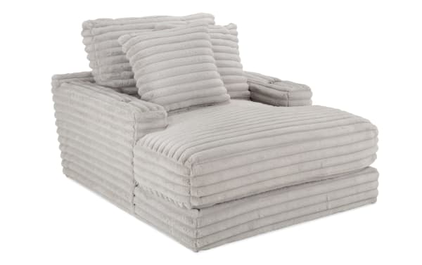 Gray Sofia Gray Chaise with plush channel-tufted polyester fabric, Bob-O-Pedic memory foam, and two matching faux fur pillows in transitional style.