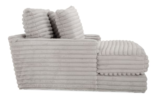 Sofia Gray Chaise in gray transitional style with plush polyester fabric, channel tufted cushions, faux fur pillows, and memory foam for luxury comfort.