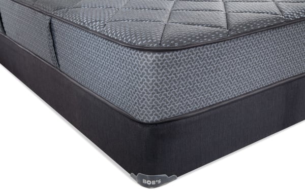 Synergy 10'' Queen Firm Standard Mattress Set by Bob's, featuring gray patterned quilted top, breathable foam layers, and dark fabric foundation for firm support.