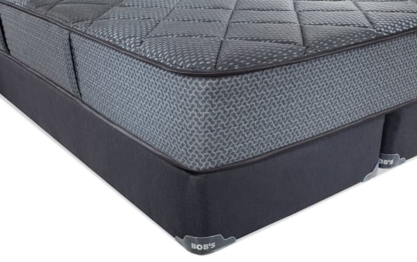 Synergy 10'' King Firm Split Standard Mattress Set with gray patterned quilted top, dark gray base, and Bob's branded corner tags, featuring gel memory foam and individually wrapped coils for firm support and temperature regulation.