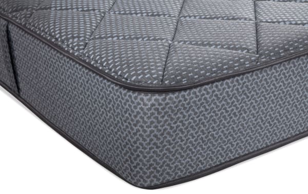 King firm mattress from the Synergy collection featuring a gray quilted top, patterned sides, and reinforced edges for durable support.
