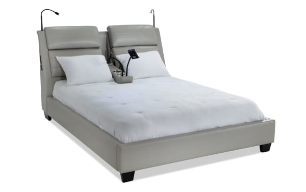 Alpha King Gray Upholstered Platform Bed in contemporary style with gray faux leather, built-in speakers, reading lights, and wireless charging dock.