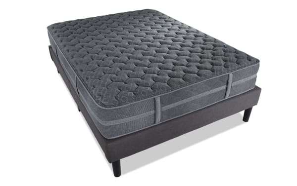 Treasure 12.5'' Twin Pillow Top Plush Mattress Set in dark gray with quilted knit cover, plush pillow top, and sturdy black legs, offering breathable, gel-infused foam comfort and firm edge support.
