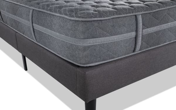 Treasure 12.5" Twin Pillow Top Plush Universal Mattress Set in gray with quilted knit cover, plush cushioning, and firm perimeter coil edge support on dark gray upholstered foundation.