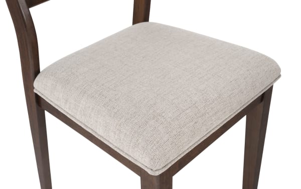 Beige fabric-upholstered dining chair seat with solid mango wood frame, part of Mango Dining collection, featuring contemporary panel back design.