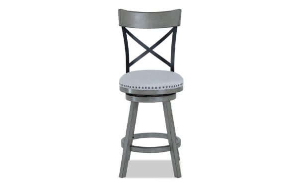 Gray Iris Dining transitional swivel stool with adjustable height, cross back, nailhead trim, and upholstered polyester fabric seat on rubberwood legs