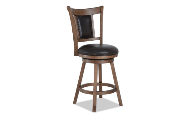Owen Brown Faux Leather Upholstered Adjustable Height Swivel Stool with nailhead trim, brown faux leather seat and back, and wooden frame in transitional style.