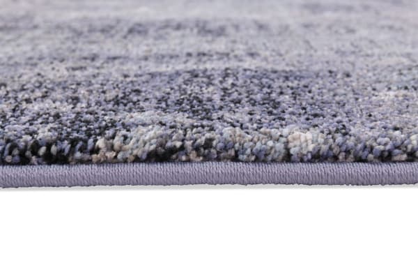 Close-up of Bayou 5' x 7' Gray Abstract Rug edge, showing soft, dense polyester and polypropylene fibers in a transitional gray pattern, durable and easy-to-clean.