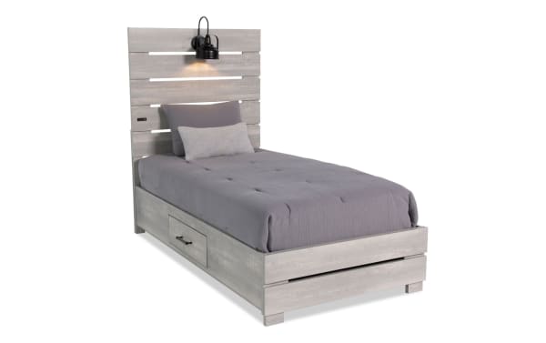 Foundry Twin White Storage Platform Bed in rustic MDF and engineered wood grain, featuring paneled slat headboard with black lamps and USB port.
