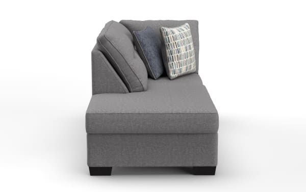 Modern gray fabric chaise lounge sofa with dark wooden legs, featuring three accent pillows in blue and patterned designs, ideal for living room seating.
