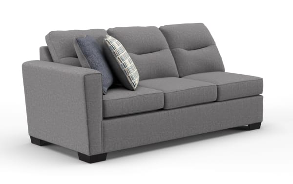 Gray fabric three-seater sofa with plush cushions, two decorative pillows, and dark wooden legs, suitable for modern living rooms.