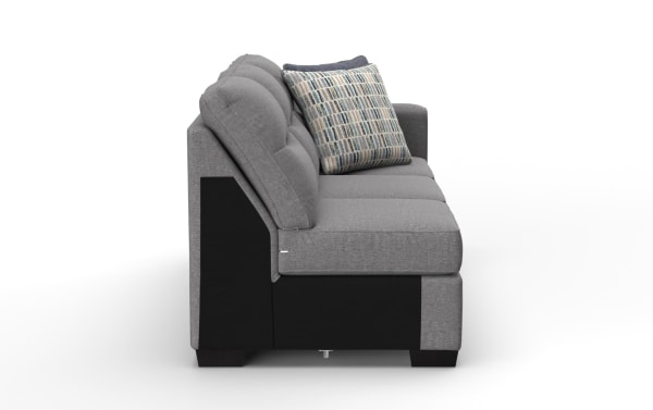 Modern gray fabric sofa with black base and wooden legs, featuring plush cushions and a patterned accent pillow for living room seating.
