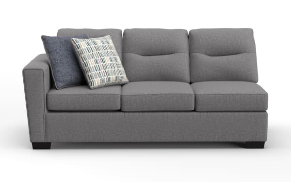 Modern gray fabric three-seater sofa with plush cushions and two decorative throw pillows, featuring a clean, contemporary design.