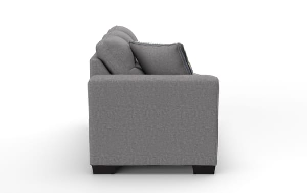 Gray fabric sofa with cushioned backrest and armrest, featuring dark wooden legs and a decorative throw pillow, side view.