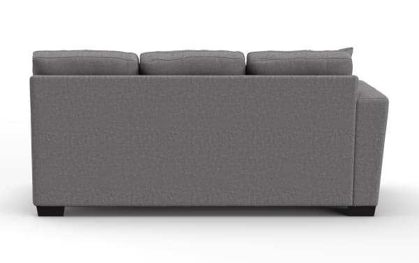 Gray fabric three-seat sofa with plush back cushions and dark wooden legs, showcasing a modern and minimalist design.