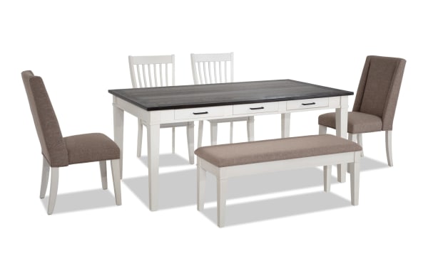 Montana 6 Piece Rustic Dining Set with white rubberwood base, distressed oak veneer top, beige polyester upholstered chairs, and storage bench with memory foam seat.