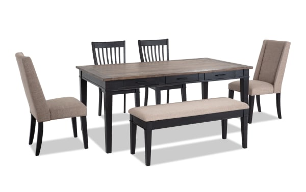 Montana 6 Piece Rustic Dining Set with black rubberwood base, beige polyester upholstered chairs, oak veneer top, and storage bench with memory foam seating.