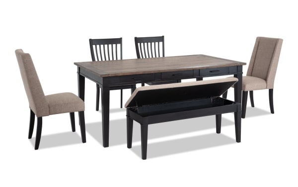 Montana 6 Piece Rustic Dining Set with black rubberwood base, distressed oak veneer top, beige polyester upholstered chairs, and a storage bench with memory foam seat.