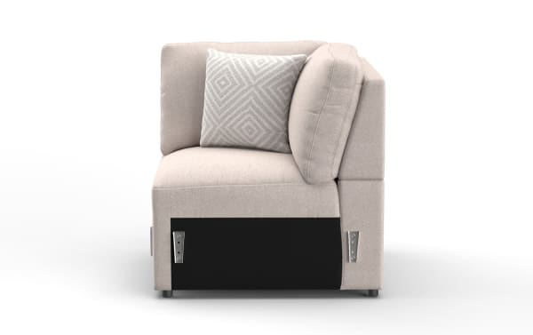 Beige fabric corner sofa section with plush cushions and a patterned throw pillow, showcasing modern modular design and soft upholstery.
