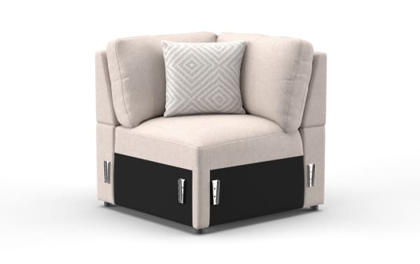 Beige fabric corner chair with cushioned backrest and patterned throw pillow, featuring black base panels and metal corner brackets.