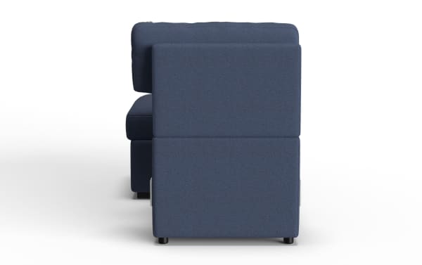 Modern navy blue fabric upholstered sofa viewed from the side, featuring clean lines, cushioned backrest, and short black legs, ideal for contemporary living rooms.