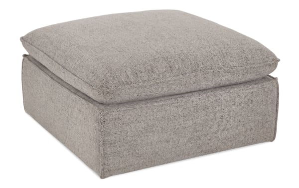 Transitional Infinity Gray Ottoman in soft gray polyester fabric with plush Bob-O-Pedic® cushion, sturdy Siberian pine frame, and no sag sinuous seating.