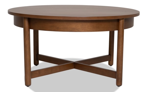 Mid-century modern Bettie Walnut Round Coffee Table with walnut wood finish, round top, and crossed leg supports from Bettie Entertainment & Occasional collection.