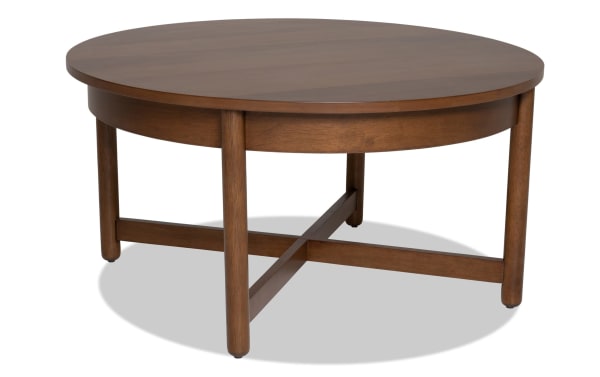 Bettie Walnut Round Coffee Table with mid-century modern style, walnut wood finish, and crossbar legs for a sleek, space-saving living room centerpiece.