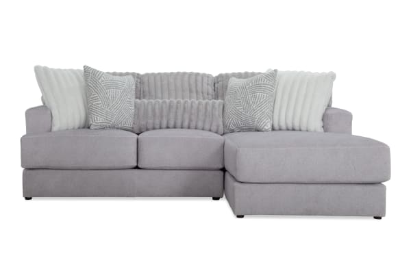 Sofia Gray 98'' 2 Piece Right Arm Facing Chaise Sectional in gray polyester fabric with transitional style, channel tufted back cushions, and five faux fur pillows for luxury and comfort.
