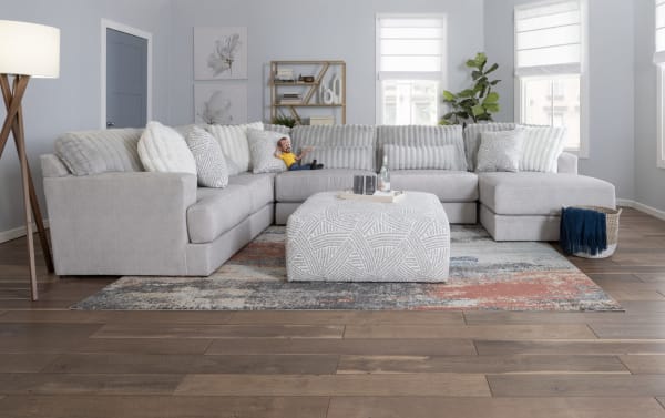 Gray Sofia Gray 98'' 2 Piece Right Arm Facing Chaise Sectional with channel tufted polyester fabric, five faux fur pillows, and plush Bob-O-Pedic Gel Memory Foam cushions in a transitional style living room setting.
