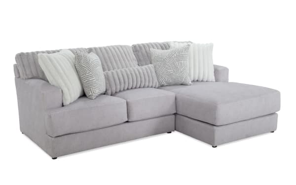 Sofia Gray 98'' 2 Piece Right Arm Facing Chaise Sectional in gray polyester fabric, transitional style with channel tufted back cushions and five faux fur pillows for luxury and comfort.