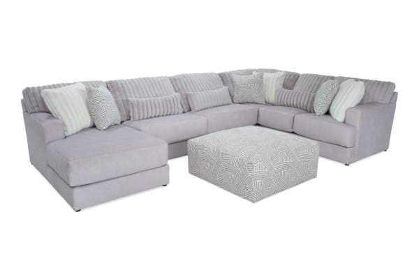 Sofia Gray 159'' 4-piece left arm facing chaise sectional with patterned ottoman, gray polyester fabric, transitional style, channel tufted back cushions, and nine faux fur pillows for luxury and comfort.