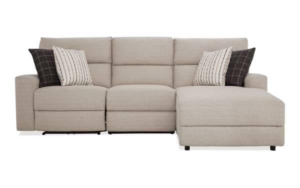 Modern Farmhouse beige 106'' power reclining 3-piece sectional with right arm chaise, armless recliner, power headrest, polyester fabric upholstery, and decorative pillows.
