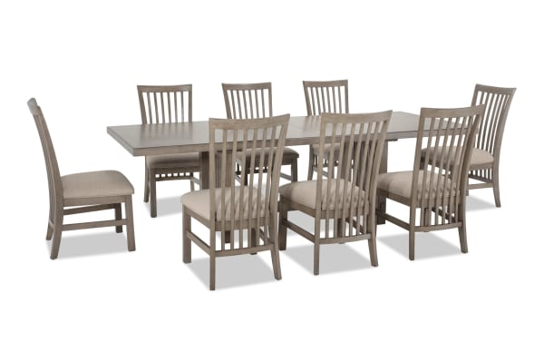 Artisan 9 Piece Gray Upholstered Extendable Dining Set with beige polyester fabric seats, oak veneer table, and two 14" leaves, transitional style.