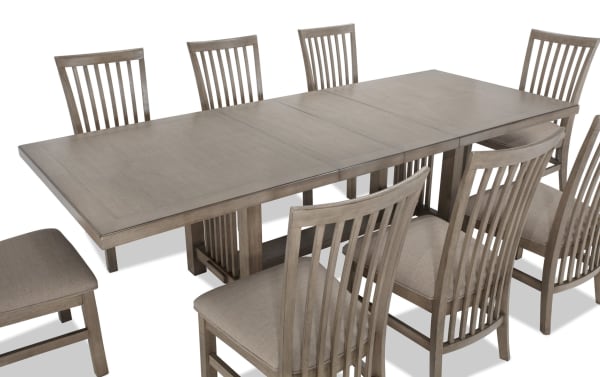 Artisan 9 Piece Gray Upholstered Extendable Dining Set with beige polyester fabric seats, oak veneer tabletop, and transitional style chairs.