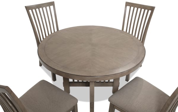 Artisan 5 Piece Gray Round Upholstered Dining Set with beige polyester fabric seats, oak veneer tabletop, and Asian hardwood solids in a transitional style.