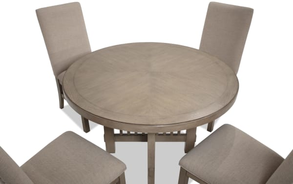 Artisan 5 Piece Gray Round Upholstered Dining Set with beige polyester fabric chairs, oak veneer round table, nailhead trim, transitional style.