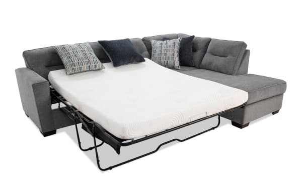 Dylan Slate 112" 2-piece right arm facing sleeper chaise sectional in gray polyester fabric with transitional style, queen gel memory foam mattress, and four accent pillows.