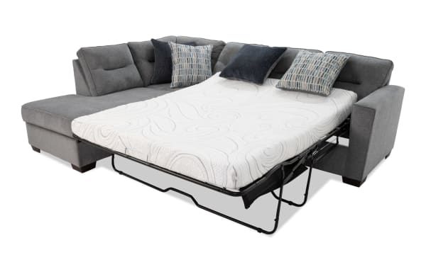 Dylan Slate 112" 2-piece left arm facing sleeper chaise sectional in gray polyester fabric with transitional style, queen cooling gel memory foam mattress, four accent pillows, and sturdy ottoman.