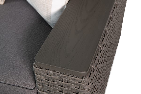 Gray wicker armrest and dark gray fabric cushion detail of the Cottage Chic Gray Wicker Outdoor Sofa, featuring powder-coated metal frame and polyester upholstery.