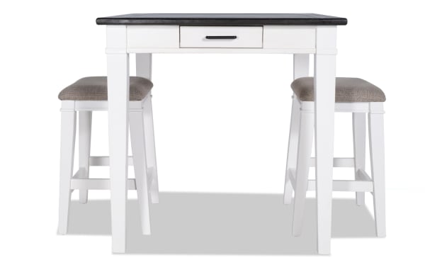 Montana 3 Piece White & Beige Upholstered Counter Height Dining Set with rustic rubberwood, oak veneer top, fabric polyester stools, and storage drawer.