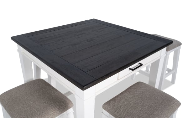 Montana 5 Piece White & Beige Upholstered Counter Height Dining Set with rustic black oak veneer top, white rubberwood base, fabric cushioned stools.