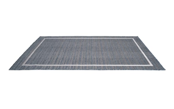 Contemporary Tides 5' x 7' blue geometric indoor/outdoor rug with flat pile, machine-woven polypropylene for durability and weather resistance.