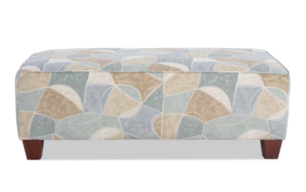 Brynn Beige Ottoman in transitional style with beige multi-patterned polyester fabric upholstery, cushioned top, and wooden legs for cozy seating or footrest.